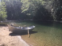 Shiny boat sitting on the bank of the Kalama river near Beginner hole